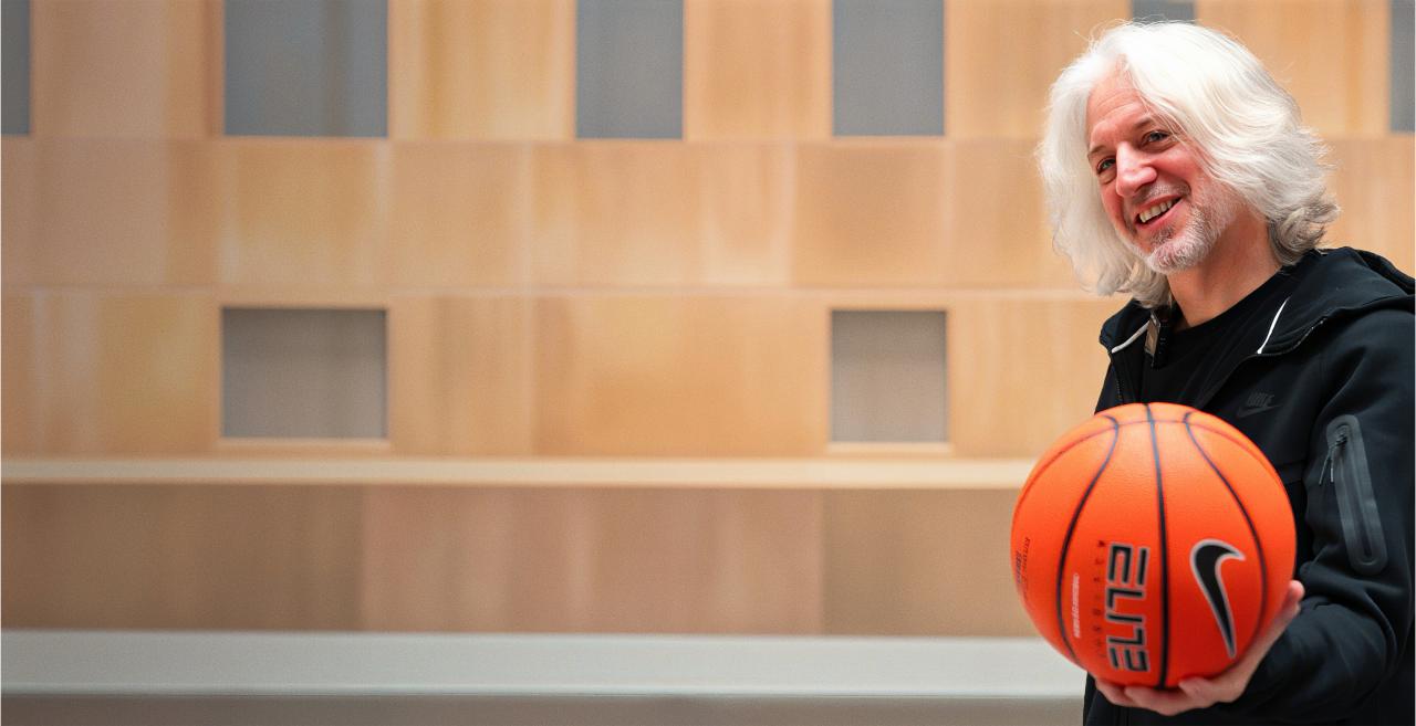 David Hollander smiling and holding a basketball outside