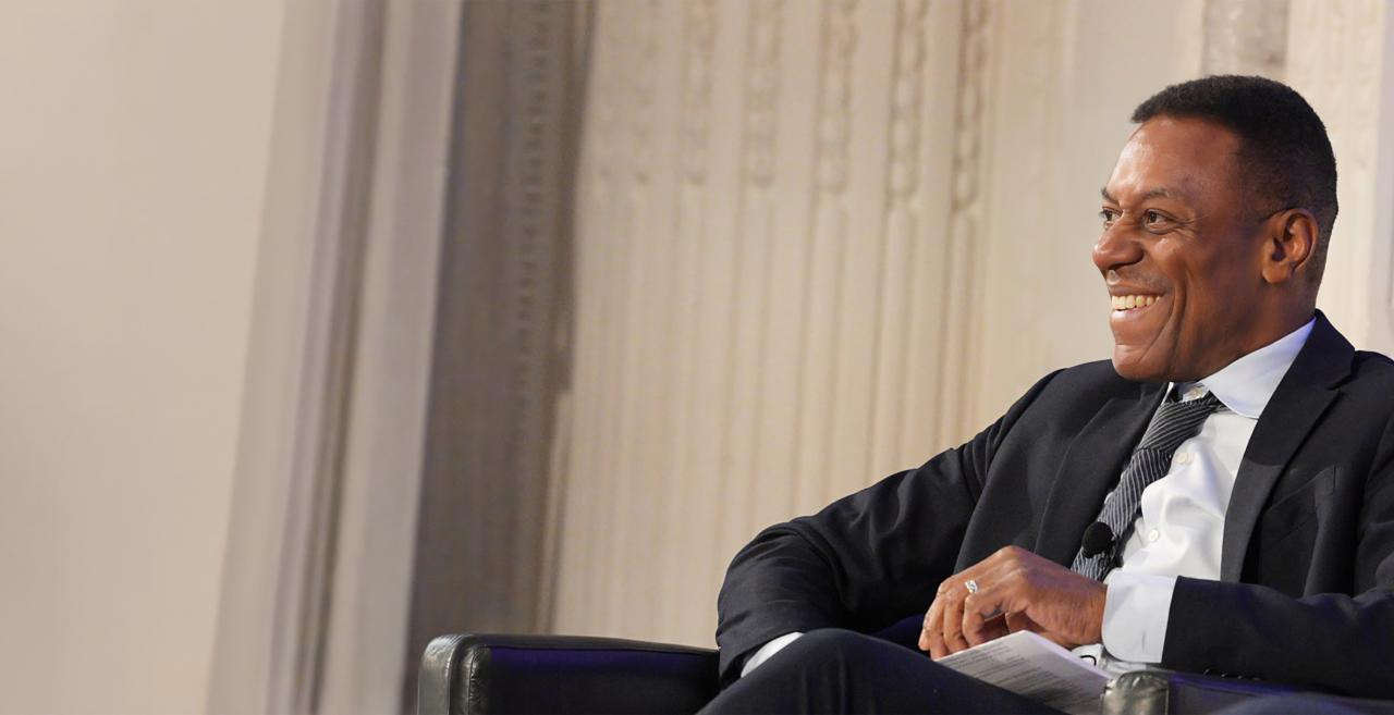Marc Norman seated and smiling while speaking during a panel discussion