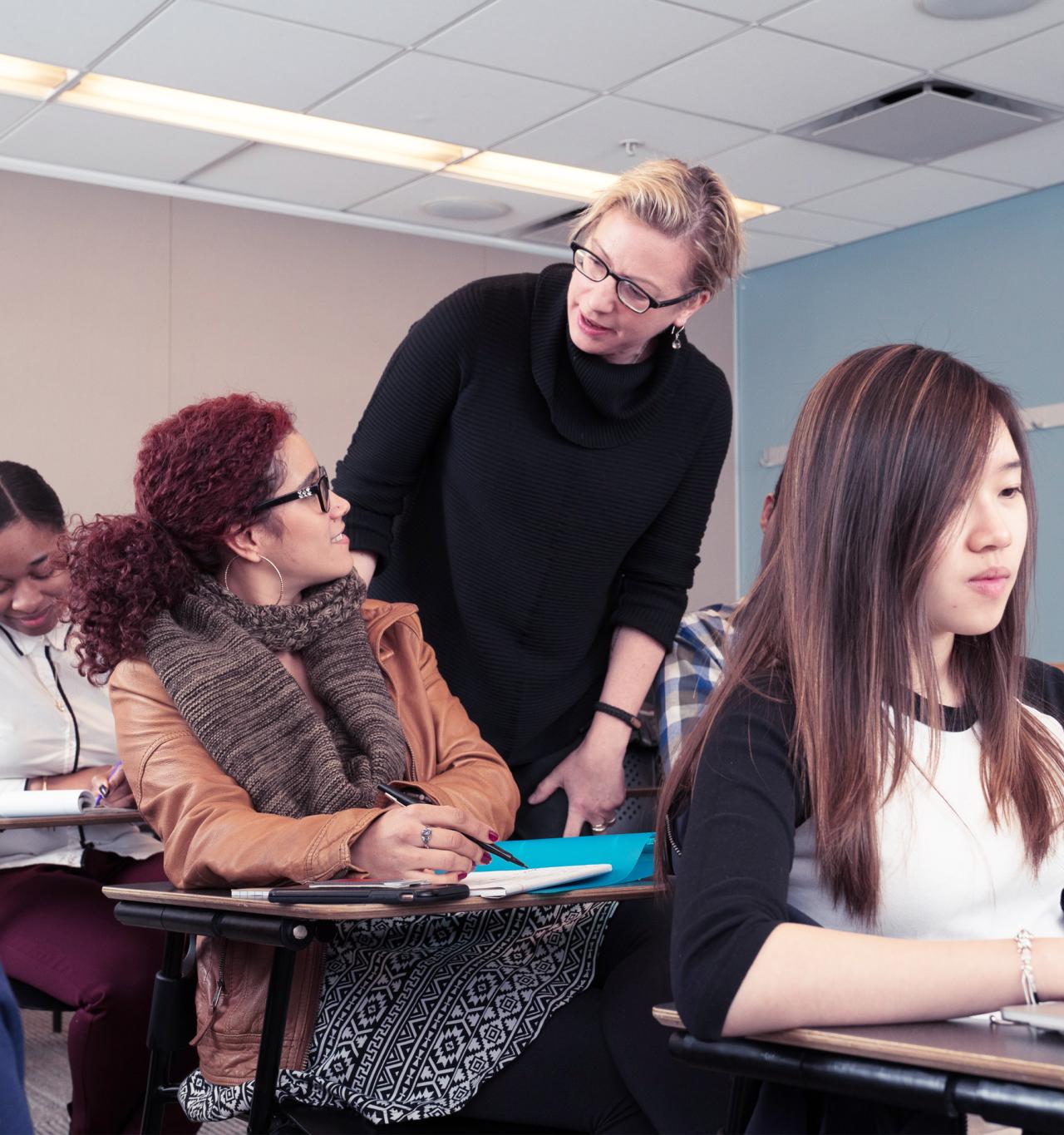 A professor mentoring a young female student, offering guidance and support in an academic setting