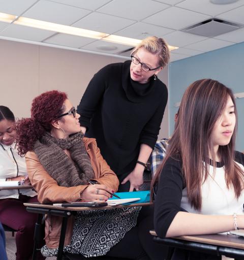 Faculty member with students in classroom