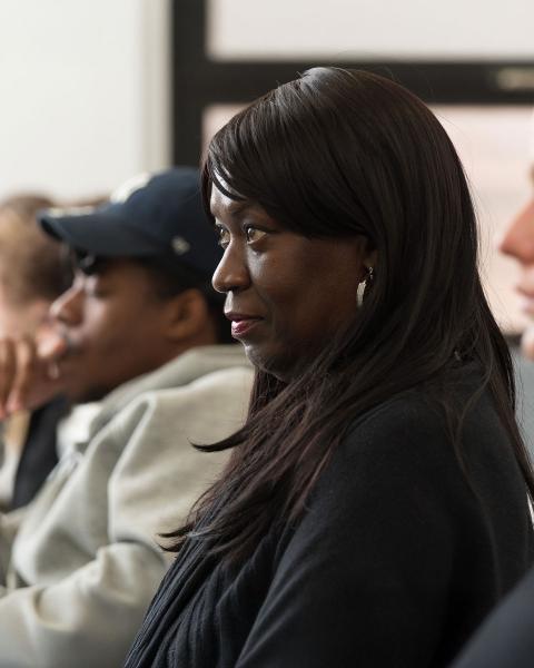 A young woman student looks forward and pays attention.