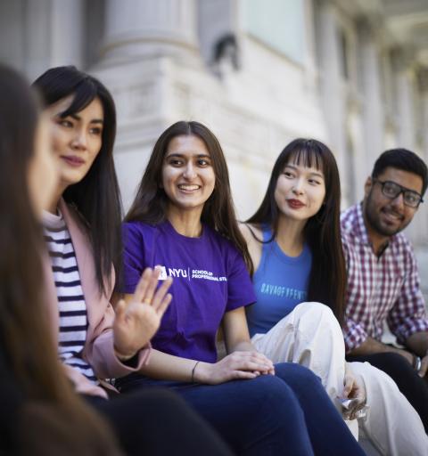Five Diversity Scholarship students sit outside of the NYU SPS campus in front of a building