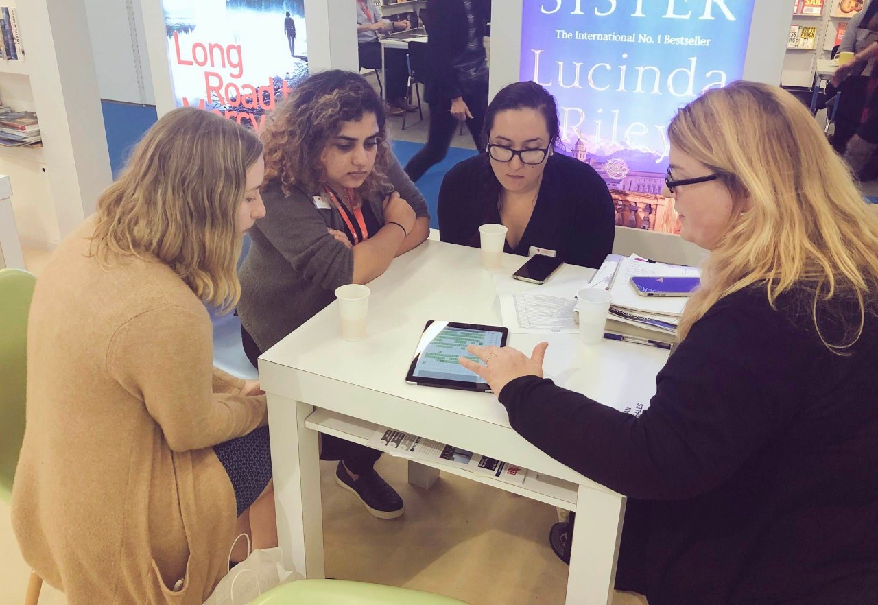 3 students sitting and speaking with Holly Ruck, Senior International Sales Manager at Macmillan