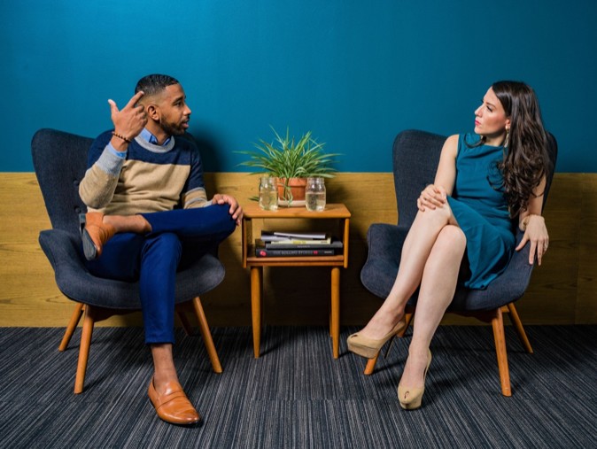 Male coaching female employee