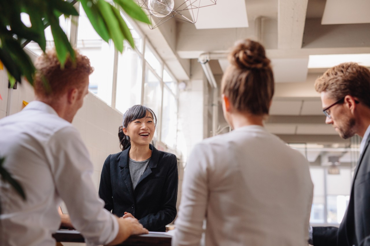 young female professional with three other professionals