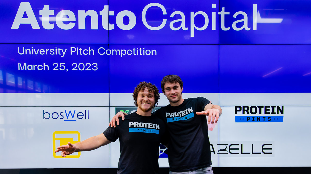 duo in front of Atento Capital screens