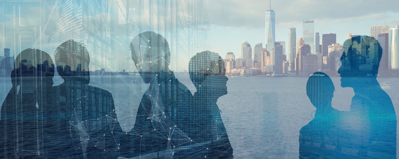 Silhouette of people in front of New York City skyline