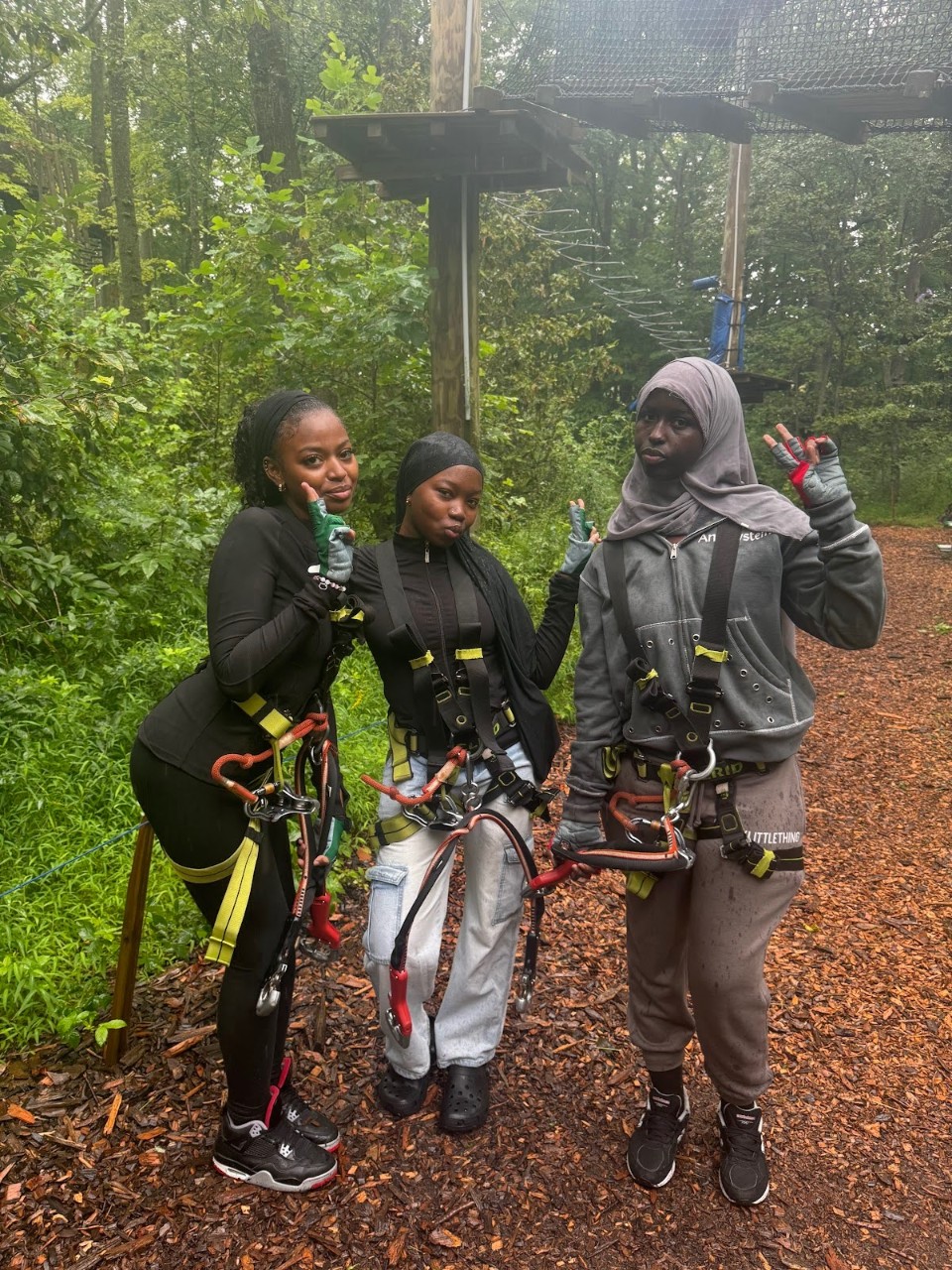 3 students in front of tree walk