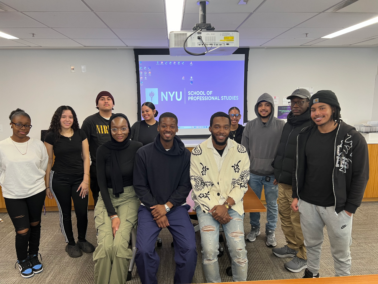 Student group photo in front of screen