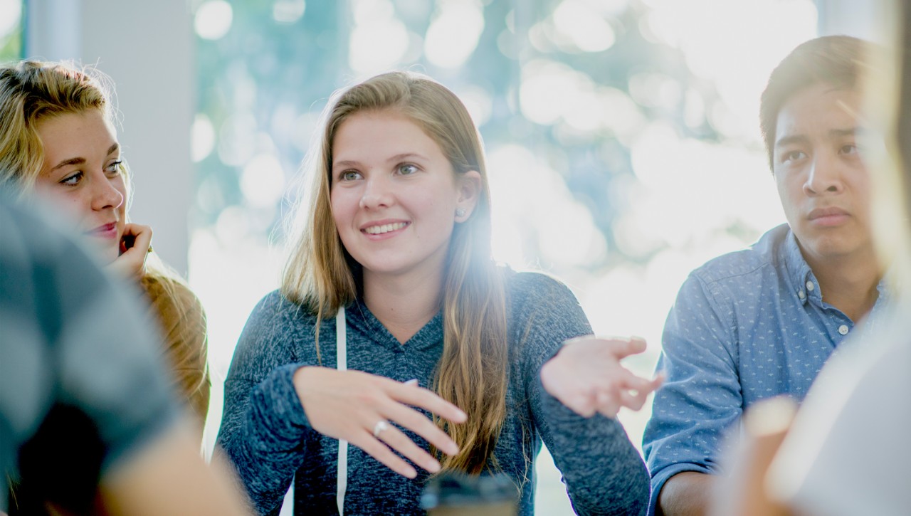 Student speaking with other students