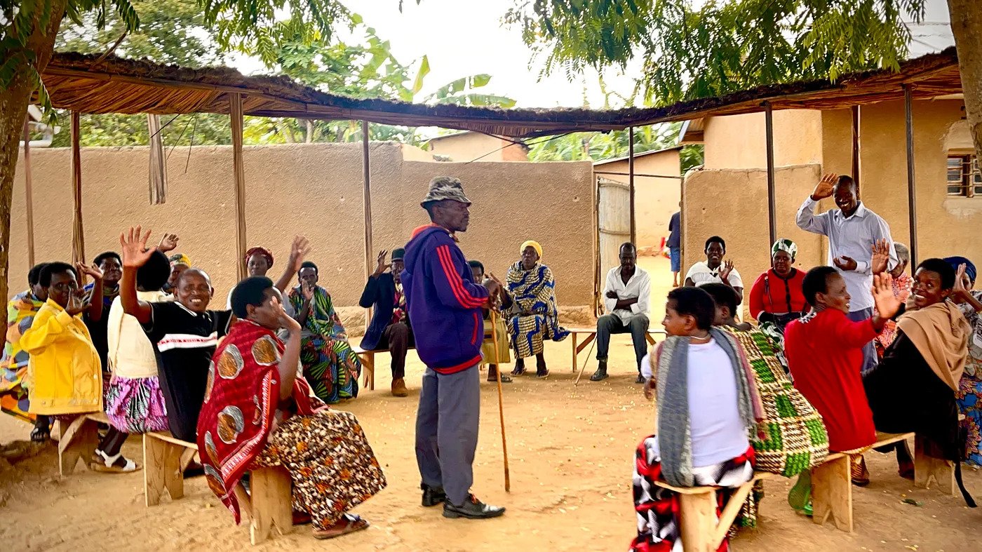 Elders and other community members at the Mbyo Reconciliation Village bid farewell to New York University students