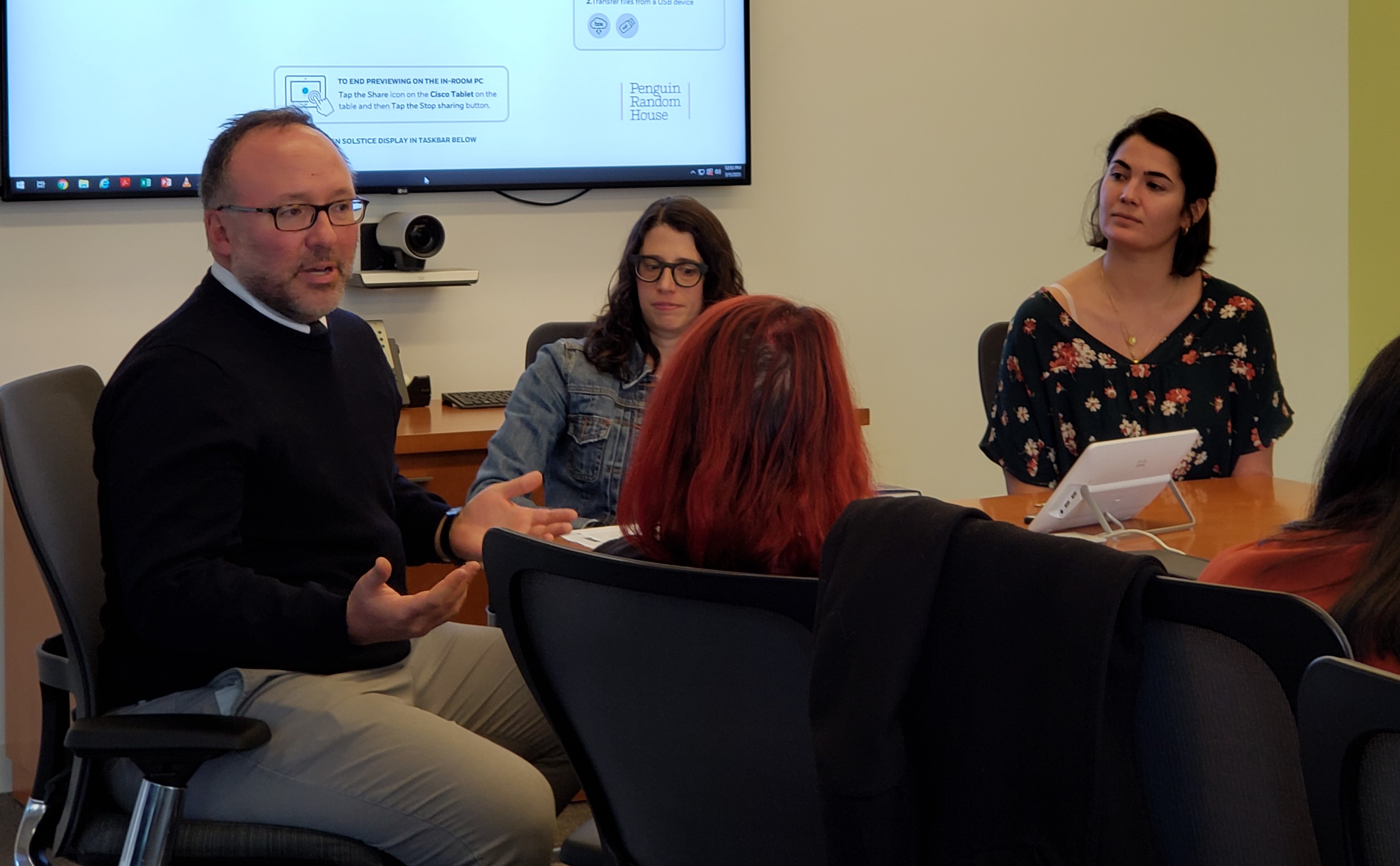 Three editors from Dutton present to a group of students in a conference room. 